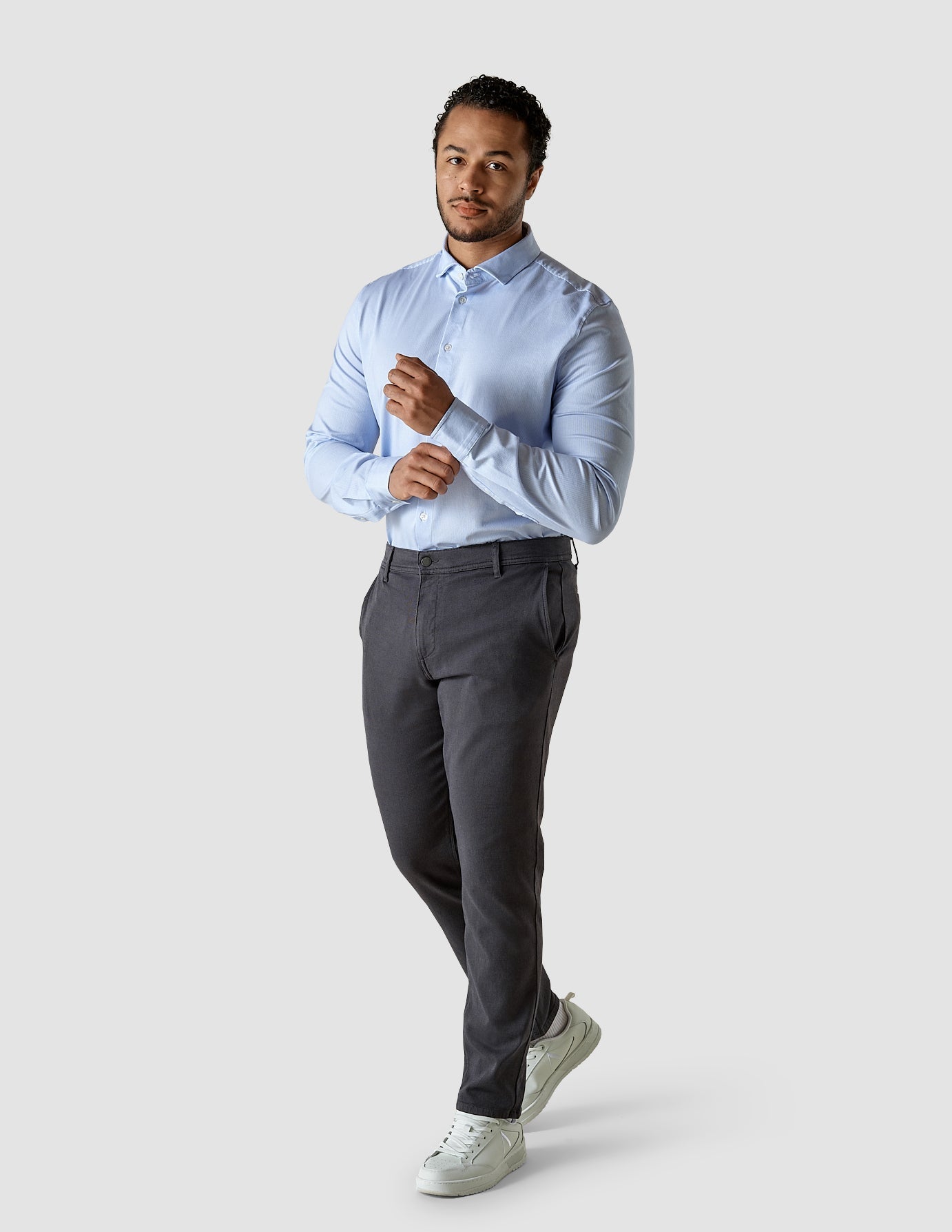 Model in full body wearing a Classic Shirt Light Blue Stripes with black pants and white sneakers